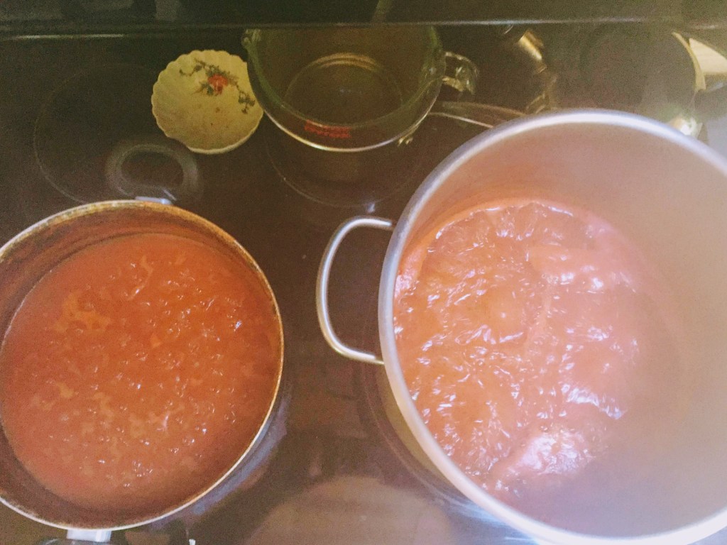 Steamy pots of tomato sauce cooking down.